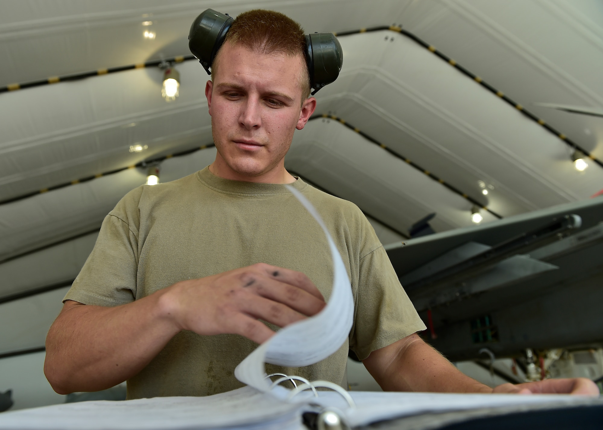 Weapons Airmen remove pylon for routine inspection