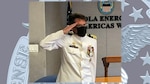 Navy Cmdr. Michael Wilson salutes