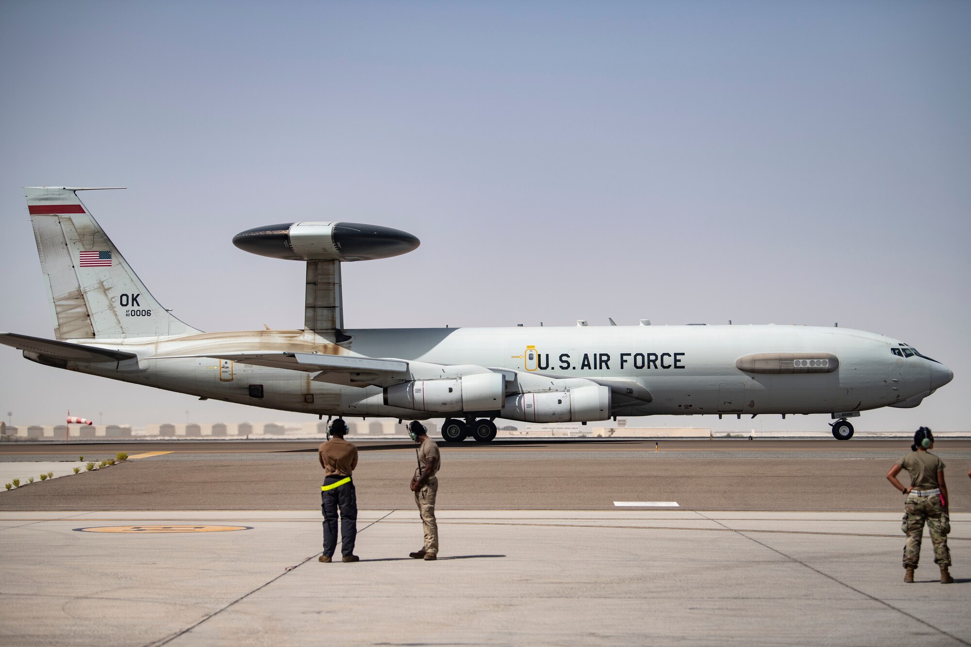 Airmen with the 380th Expeditionary Aircraft Maintenance Squadron E-3 Sentry Aircraft Maintenance Unit watch the 968th Expeditionary Airborne Air Control Squadron’s E-3 Sentry (AWACS) by for flight July 28, 2020, here.