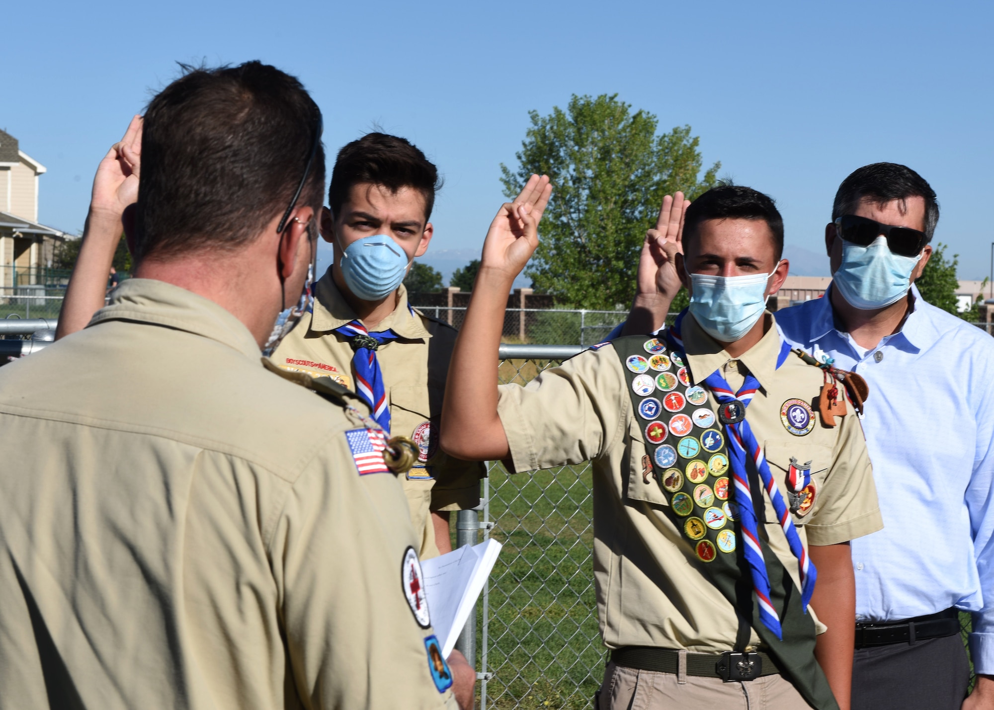 Spencer Fogg, Troop 630 Eagle Scout, participates in the Eagle Oath and Charge at the dog park on Buckley Air Force Base, Colo., Aug. 7, 2020. Fogg was promoted to Eagle Scout after successfully completing the base dog park community project. (U.S. Air Force photo by Airman 1st Class Haley N. Blevins)