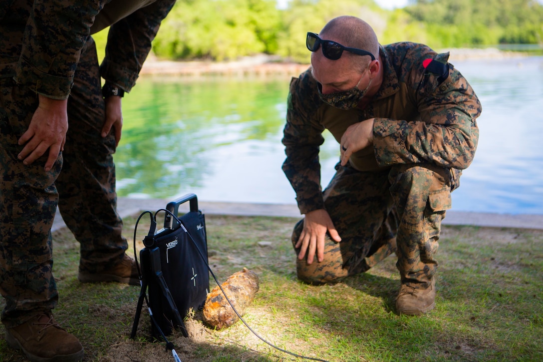 U.S. Marine sets up an expeditionary radiographic kit to capture an x-ray image of an unexploded ordnance item found in a shallow water inlet in Peleliu, Republic of Palau, July 28.
