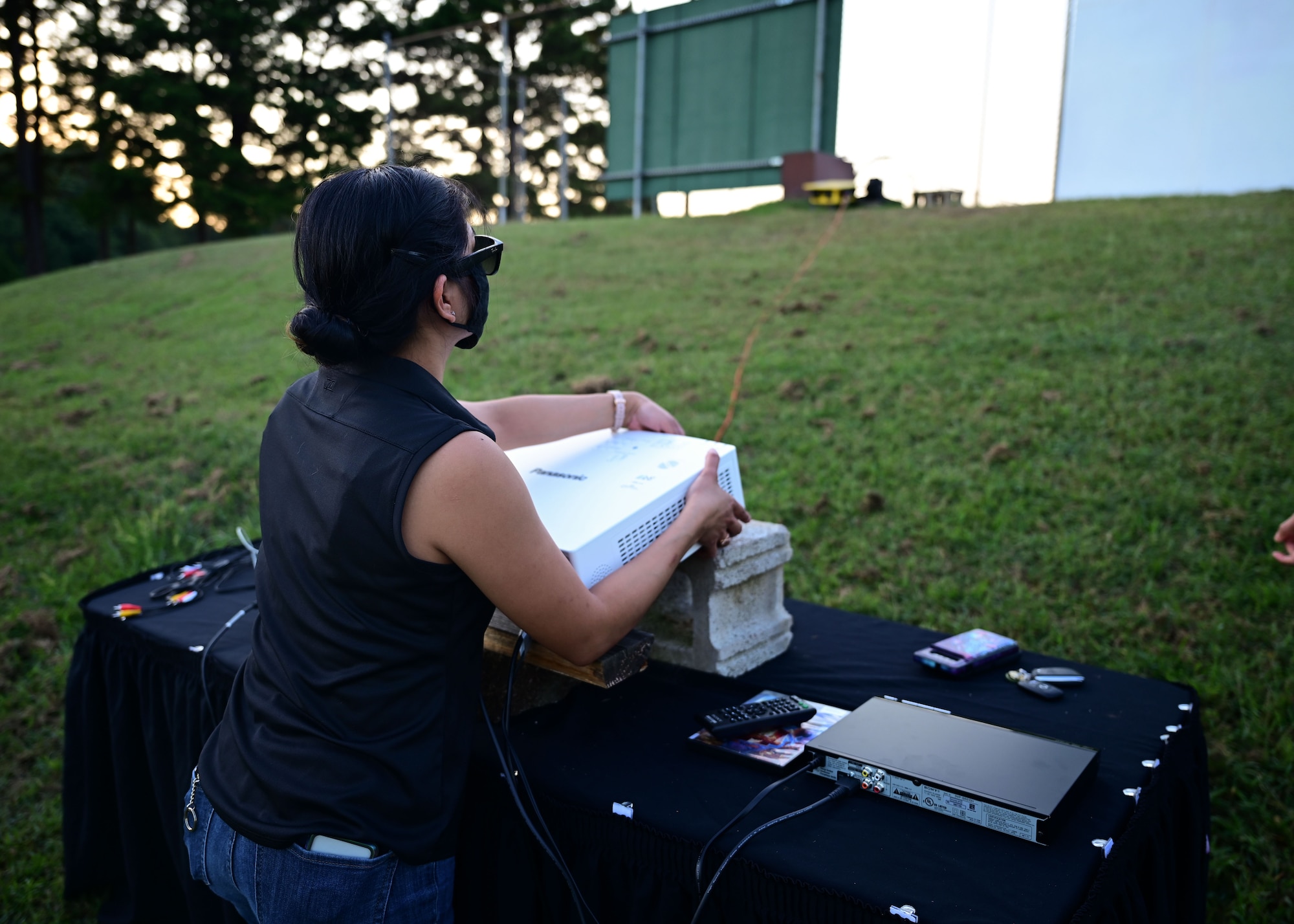 A woman prepares a movie projector