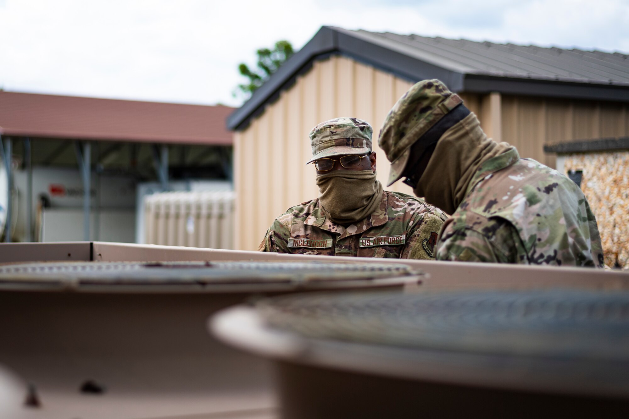 A photo of Airmen inspecting a condenser