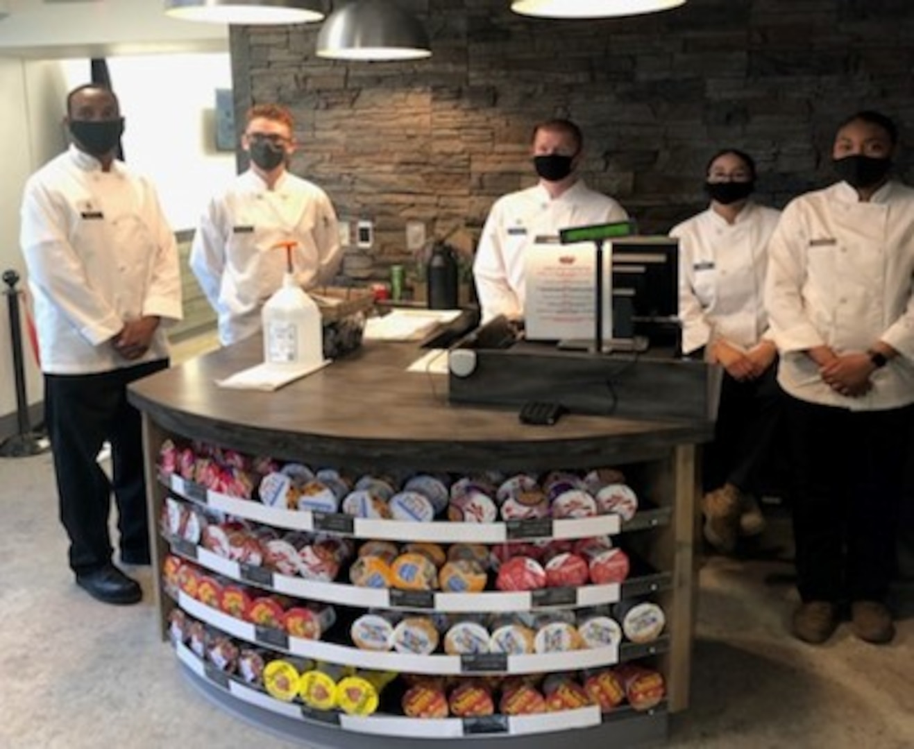 Food service workers stand ready for the opening of a new food kiosk.