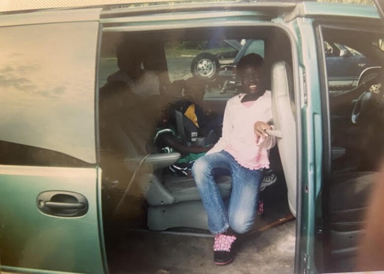 Airman 1st Class Nyarauch Chuol, passenger operations representative with the 32nd Aerial Port Squadron, poses for a photo as she helps pack the van for church with her family.