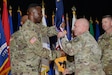 Maj. Gen Frank Muth, commanding general of U.S. Army Recruiting command, passes the Medical Recruiting Brigade colors to Col. Gary Cooper, the incoming commander, during a ceremony at Fort Knox’s Waybur Theater July 10, 2020. (Charles Leffler, Fort Knox Visual Information)