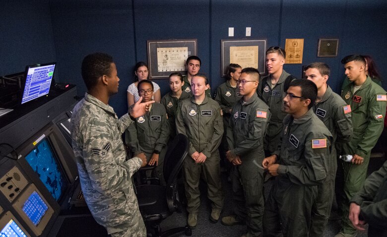 Senior Airman Kristapher Guillen, 436th Operations Support Squadron Radar Approach Control air traffic controller, answers questions from Air Force Junior Reserve Officers' Training Corps cadets during a tour of the RAPCON facility and control tower July 23, 2019, at Dover Air Force Base, Del. Cadets who attended the AFJROTC Summer Flight Academy at Delaware State University spent half of the day touring aviation-related facilities and aircraft. (U.S. Air Force photo by Roland Balik)