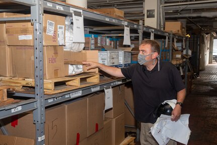 Code 530 JRC Lead Mark Ragsdale shows the various supplies located in the COVID-19 Fight Supplies Warehouse, including the face masks developed in the Sail Loft.