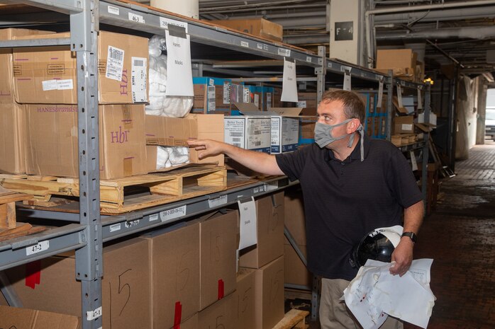 Code 530 JRC Lead Mark Ragsdale shows the various supplies located in the COVID-19 Fight Supplies Warehouse, including the face masks developed in the Sail Loft.