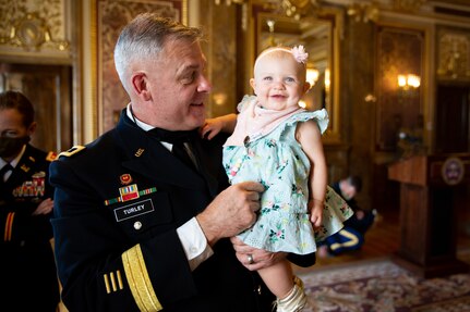 The Adjutant General, Maj. Gen. Michael J. Turley with his granddaughter at the Utah State Capitol, in the Gold Room, after his promotion ceremony Aug. 6, 2020
