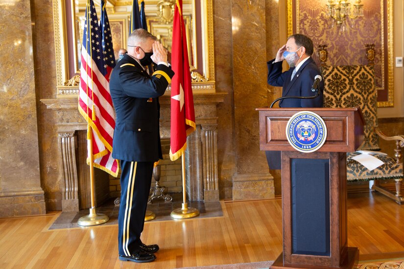 Gov. Gary R. Herbert  salutes the newly promoted Adjutant General, Maj. Gen. Michael J. Turley at the Utah State Capitol, in the Gold Room, Aug. 6, 2020.