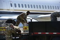 An Airman from the 5th Logistics Readiness Squadron hauls cargo at Minot Air Force Base, North Dakota, May 20, 2020. The 5th LRS modified pallets with rollers in order to efficiently change the way they work missions. (U.S. Air Force photo by Senior Airman Dillon Audit)
