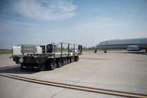 An Airman from the 5th Logistics Readiness Squadron hauls cargo at Minot Air Force Base, North Dakota, May 20, 2020. The 5th LRS modified pallets with rollers in order to efficiently change the way they work missions. (U.S. Air Force photo by Airmen 1st Class Jesse Jenny)