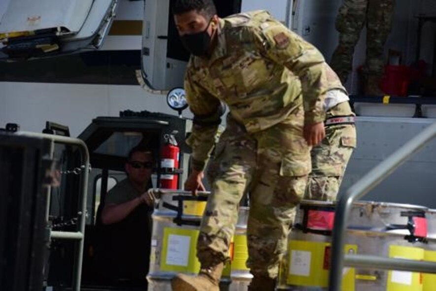 An Airman from the 5th Logistics Readiness Squadron hauls cargo at Minot Air Force Base, North Dakota, May 20, 2020. The 5th LRS modified pallets with rollers in order to efficiently change the way they work missions. (U.S. Air Force photo by Airmen 1st Class Jesse Jenny)
