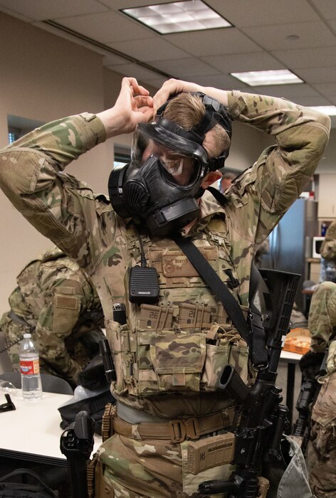 A Utah Air National Guard Airman fits a gas mask while preparing to head to downtown Salt Lake City, Utah