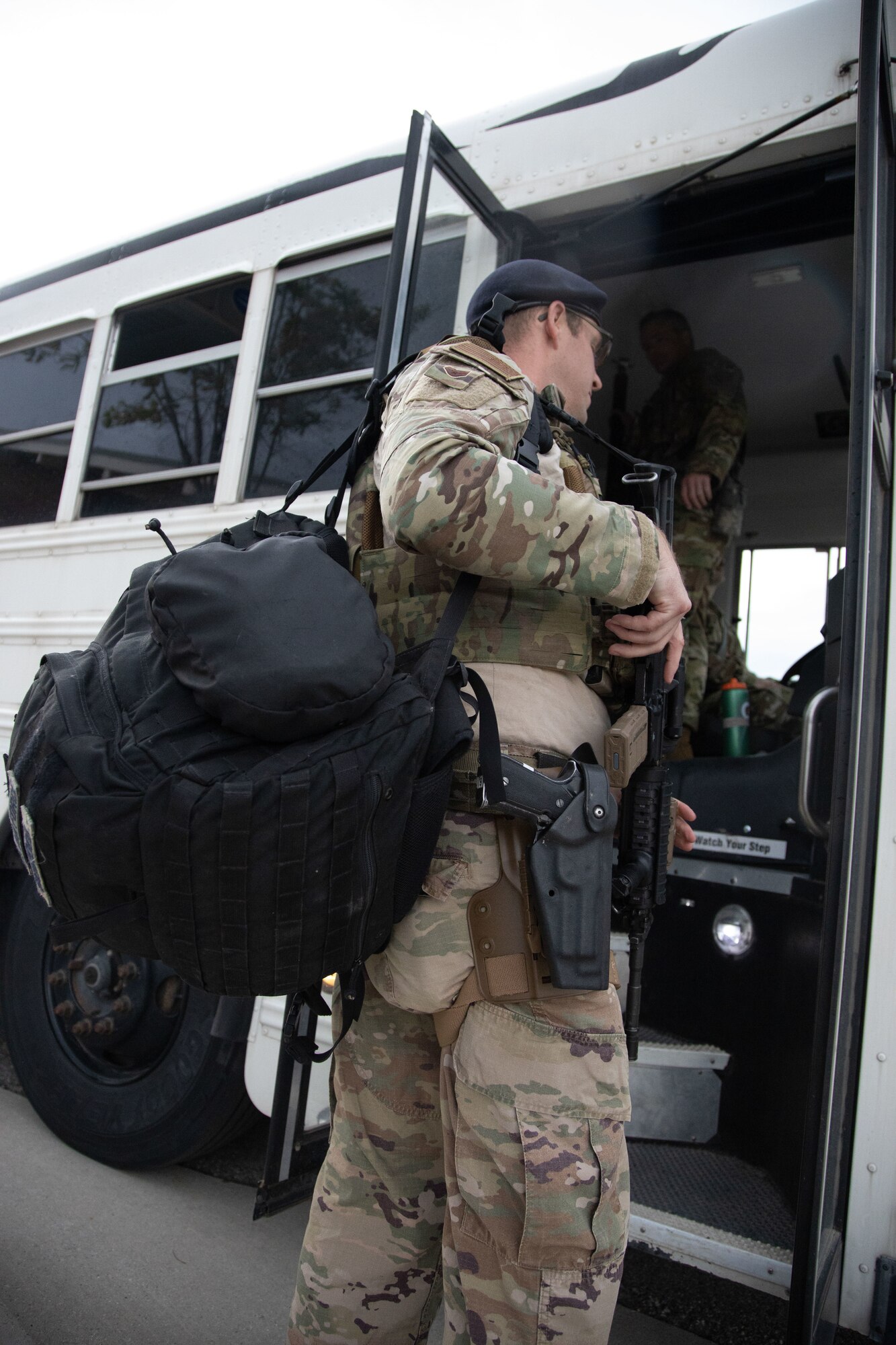 A Utah Air National Guard Airman boards a bus on their way to  downtown Salt Lake City, Utah