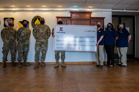 Cannon Air Force Base Army and Air Force Exchange Services management presents 27th Special Operations Wing leadership with a symbolic check representing their annual donation to the wing’s Morale, Welfare and Readiness Fund at the base July 31st, 2020. The annual donation from AAFES helps fund 27th Special Operations Force Support Squadron quality of life services. (U.S. Air Force photo by Senior Airman Maxwell Daigle)