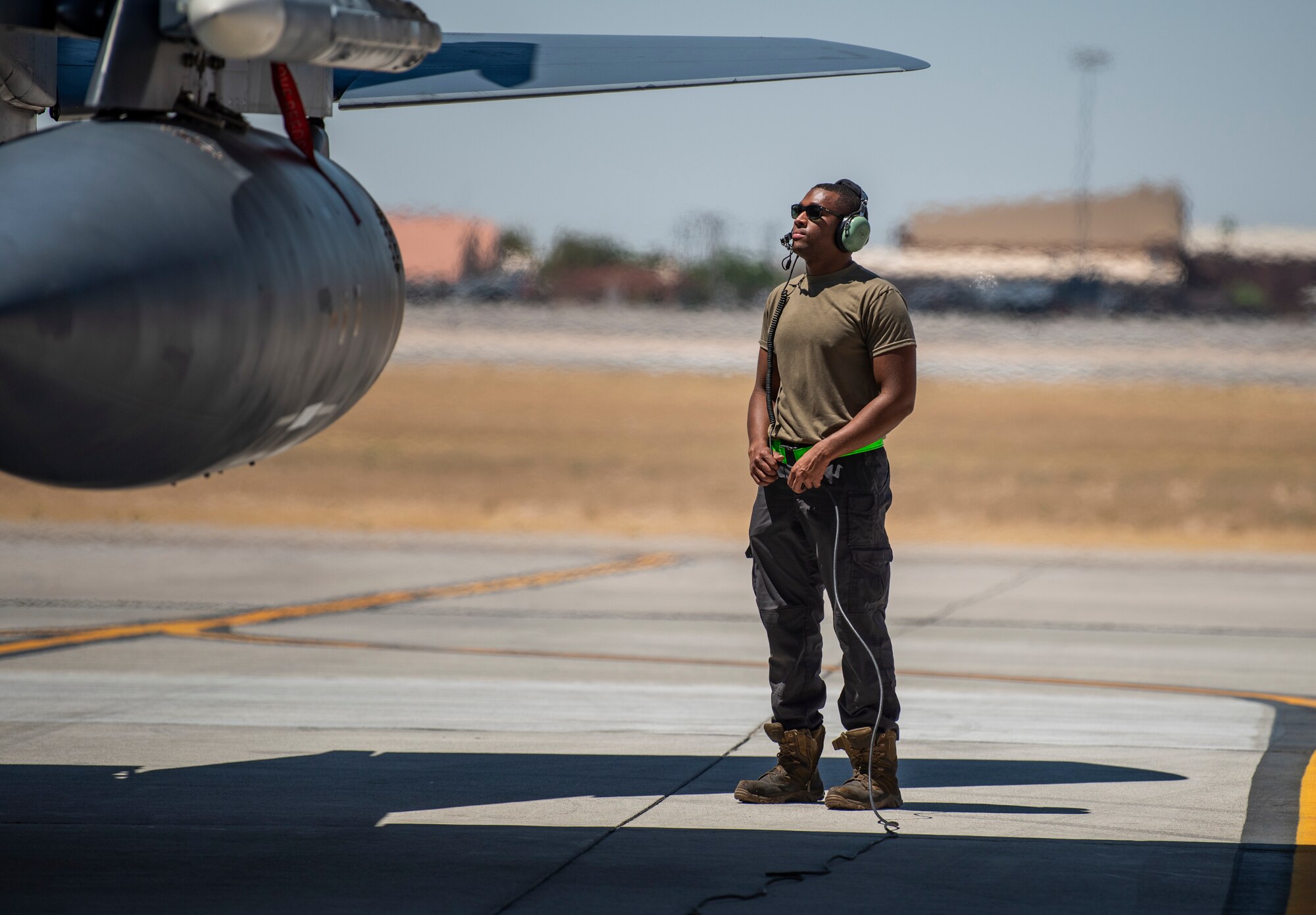 Airman stands on flight line.