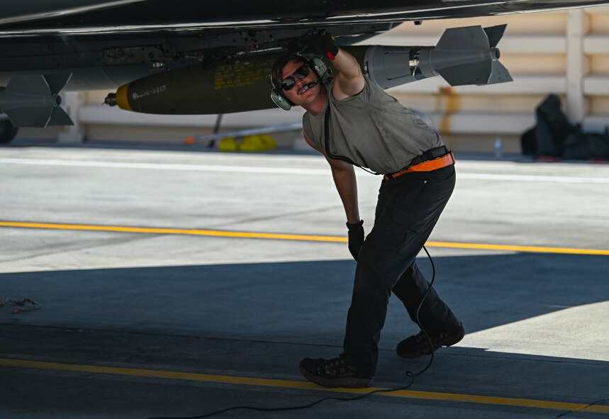 Maintainer looks under jet.