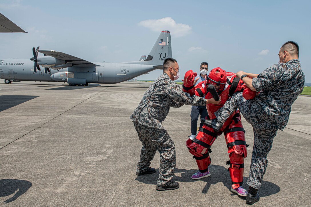 Koku-Jieitai (Japan Air Self-Defense Force) members react to simulated intruders by using combative techniques learned during a bilateral aircraft security training event at Yokota Air Base, Japan, August 7, 2020