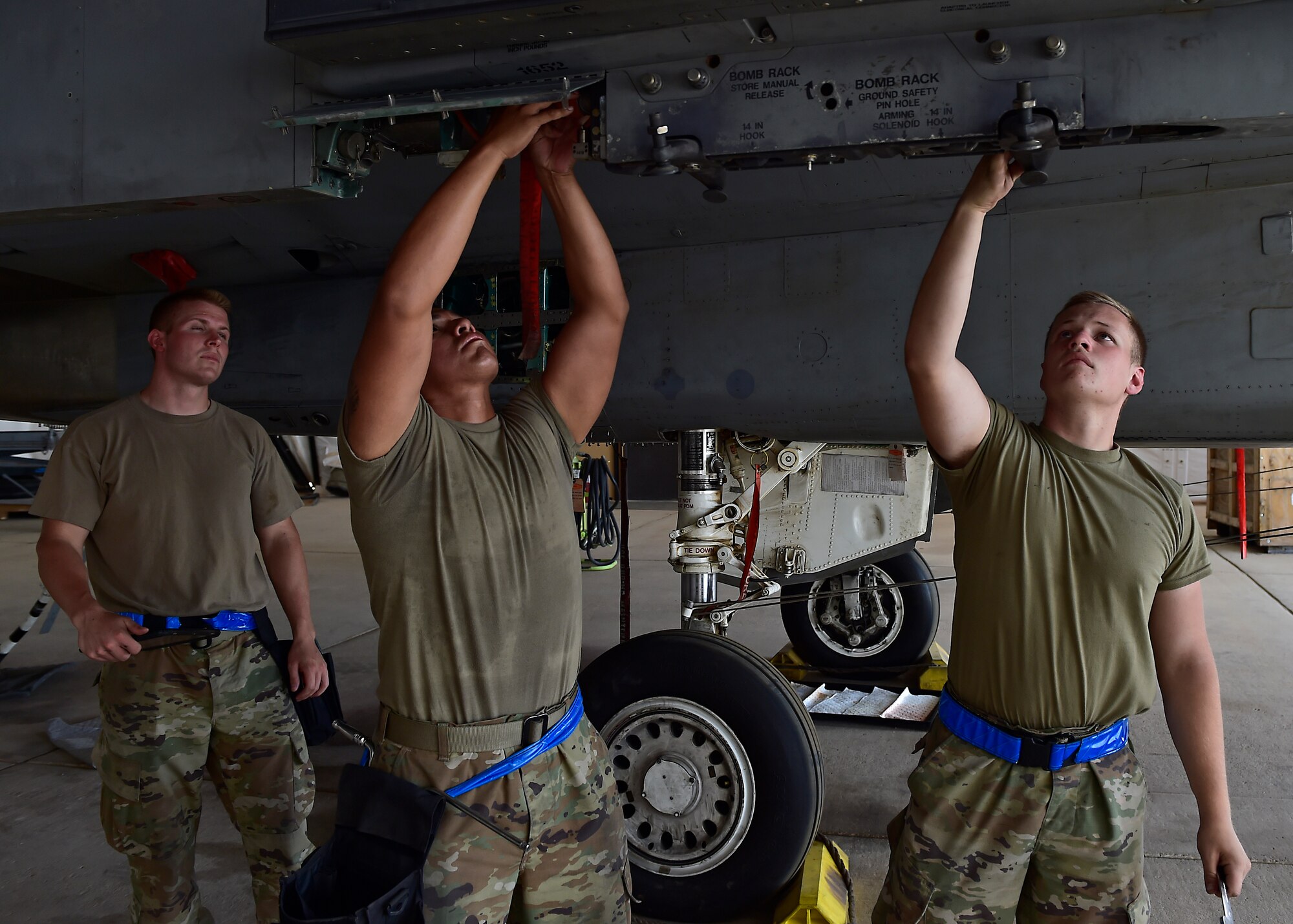 Weapons Airmen remove pylon for routine inspection