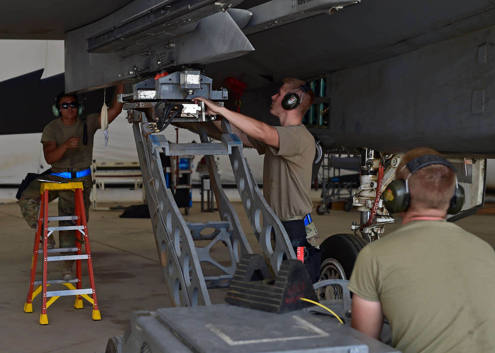 Weapons Airmen remove pylon for routine inspection