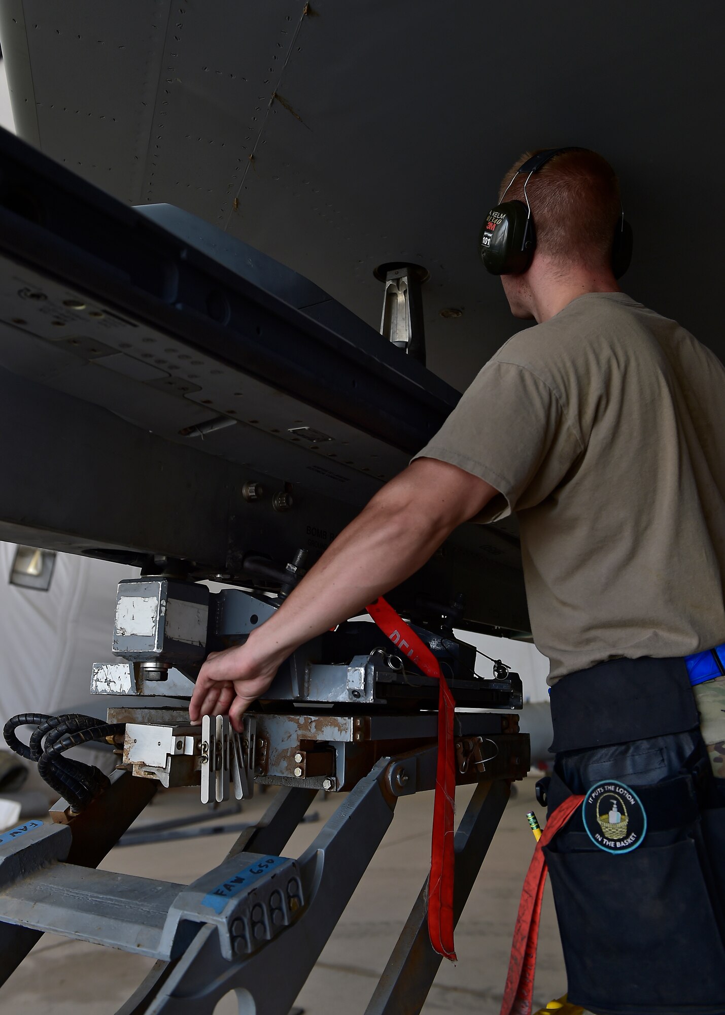 Weapons Airmen remove pylon for routine inspection