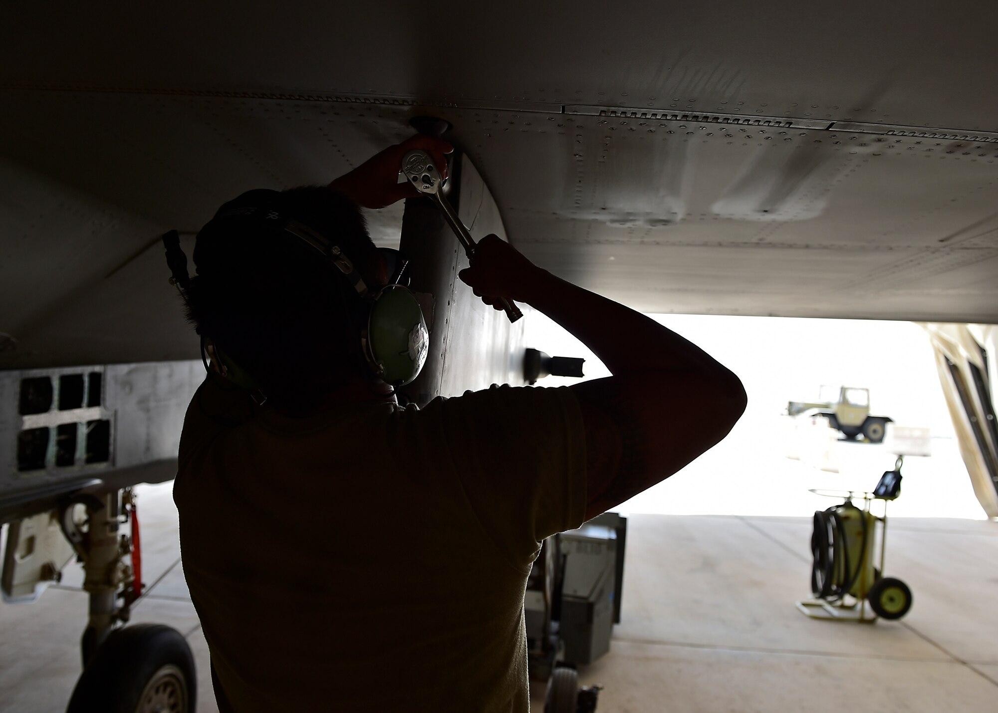 Weapons Airmen remove pylon for routine inspection
