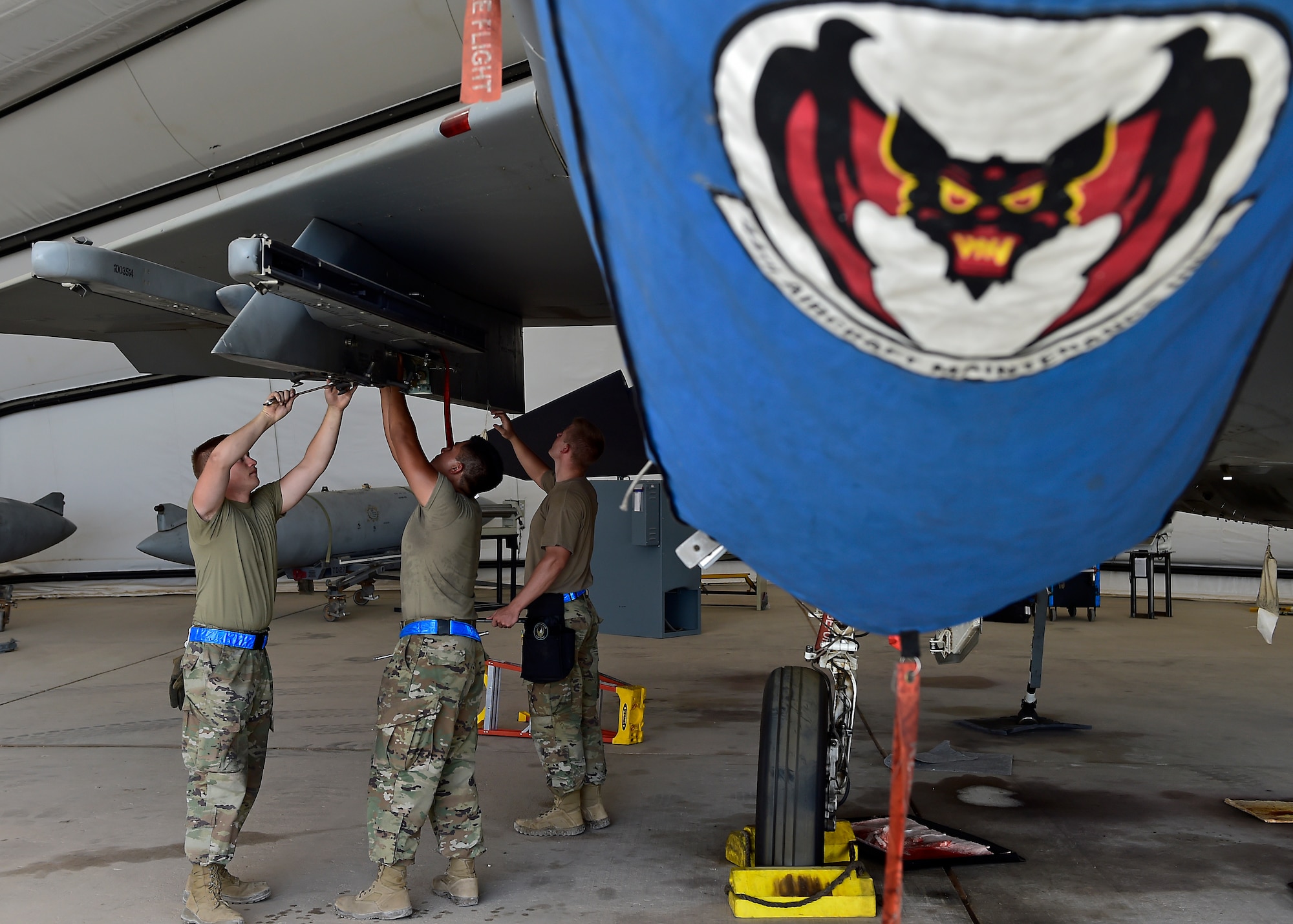 Weapons Airmen remove pylon for routine inspection