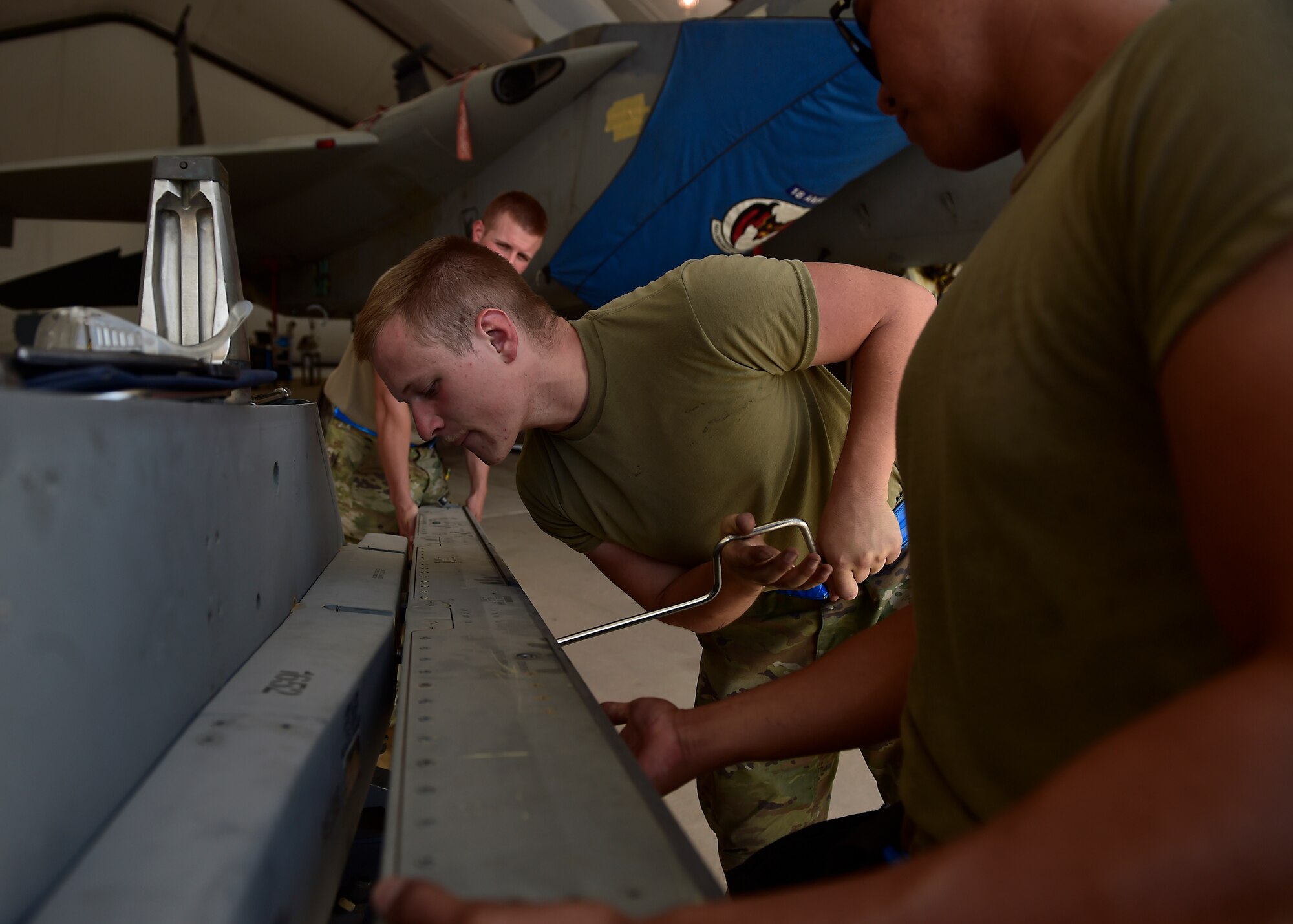 Weapons Airmen remove pylon for routine inspection