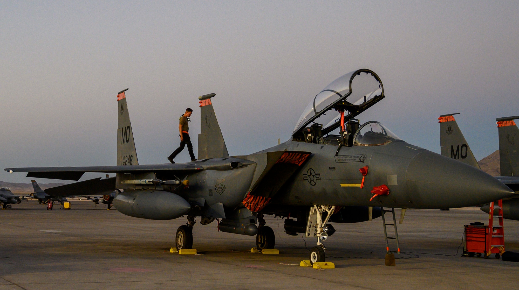 Airman walks on jet.