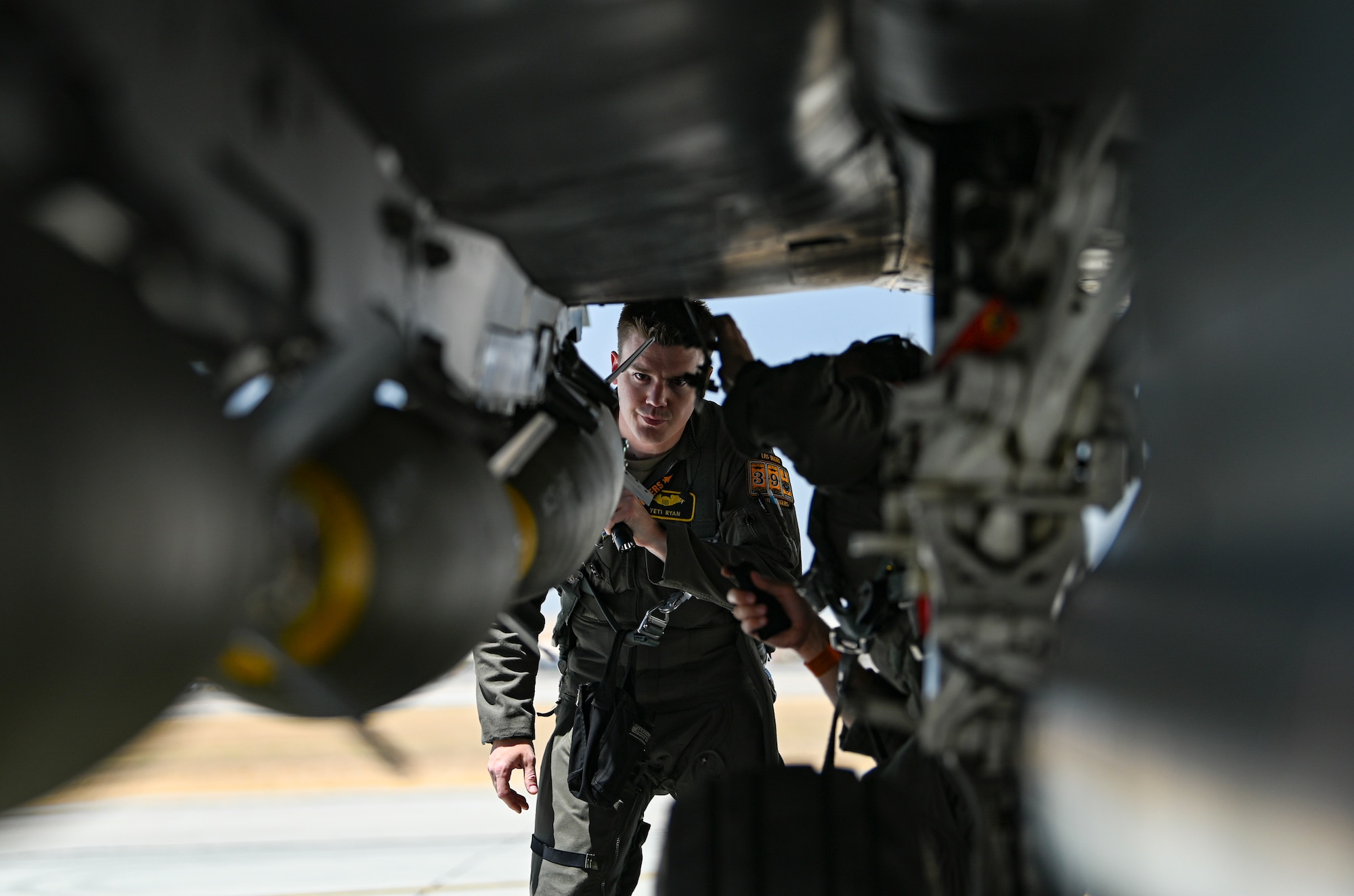 Pilot looks under jet.