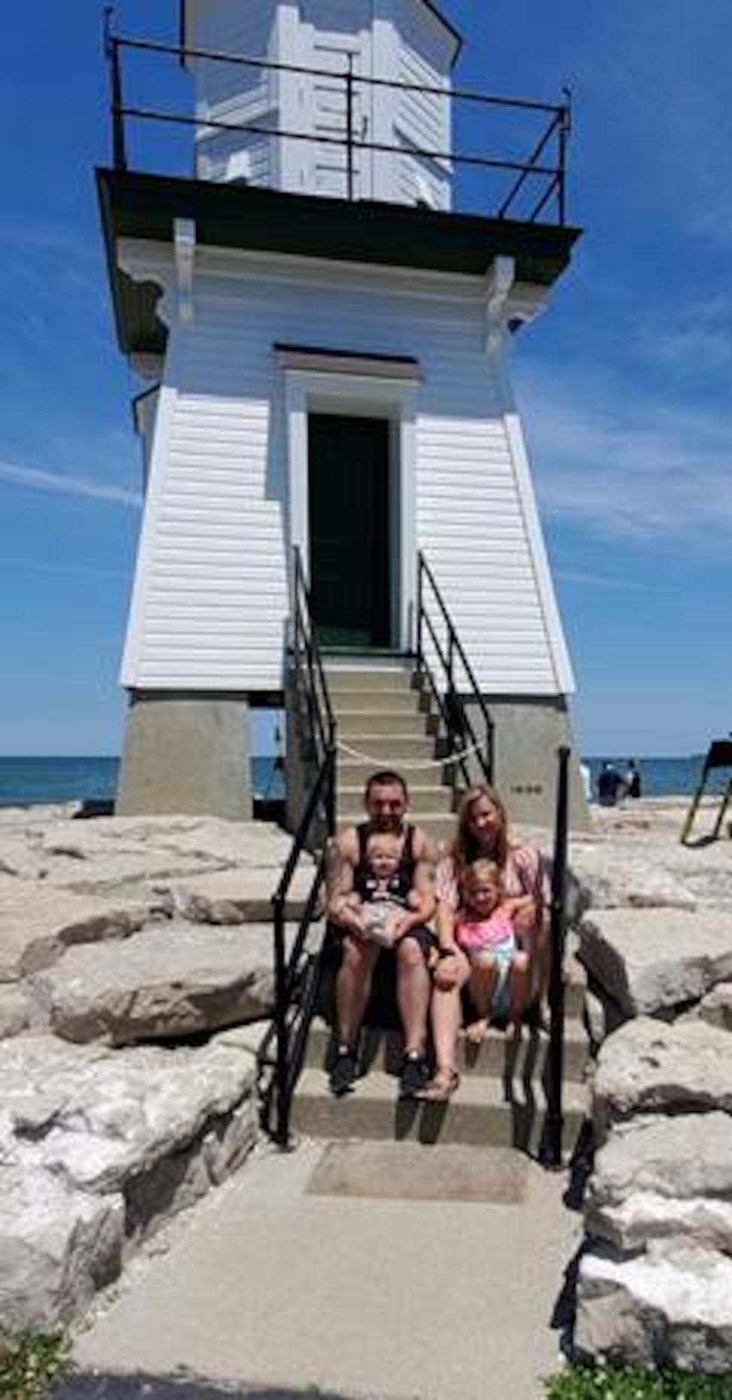 Staff Sgts Cameron and Khyrsta Gomula are with their daughters, seven-year-old Rhaynnon and one-year old Olivia. In June, the Gomulas both received their Associates degrees in Informations Systems Technology from the Community College of the Air Force.