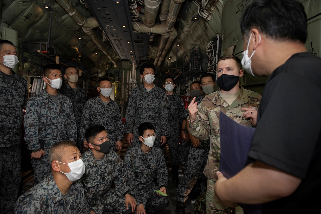 Senior Airman Dylan Crosby, 374th Security Forces Squadron NCO in charge of customs immigration and security team program manager, briefs Koku-Jieitai (Japan Air Self-Defense Force) members before starting a training scenario during the bilateral aircraft security training at Yokota Air Base, Japan, August 7, 2020.