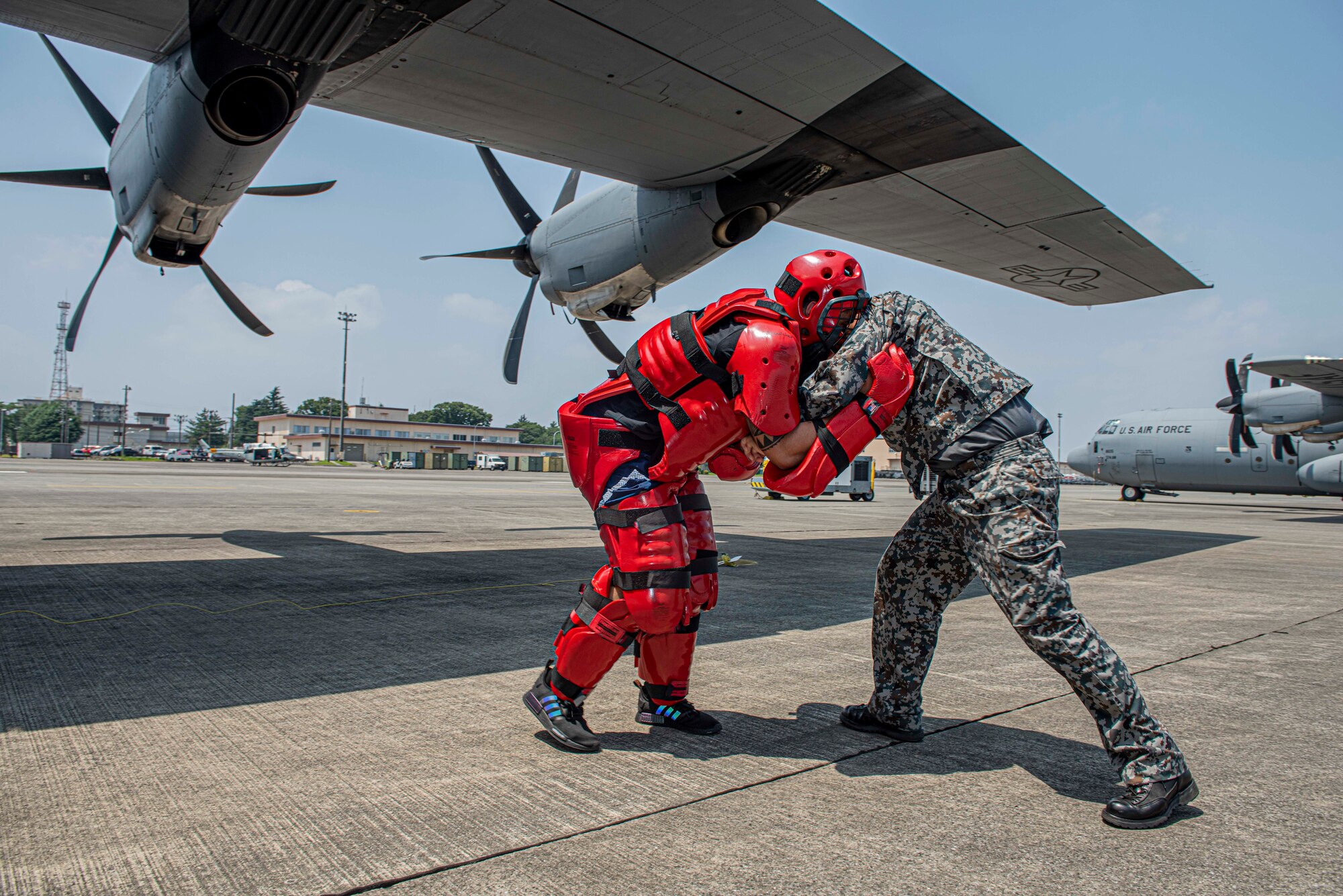 A Koku-Jieitai (Japan Air Self-Defense Force) member reacts to a simulated intruder by implementing a combative technique learned during a bilateral aircraft security training event at Yokota Air Base, Japan, August 7, 2020