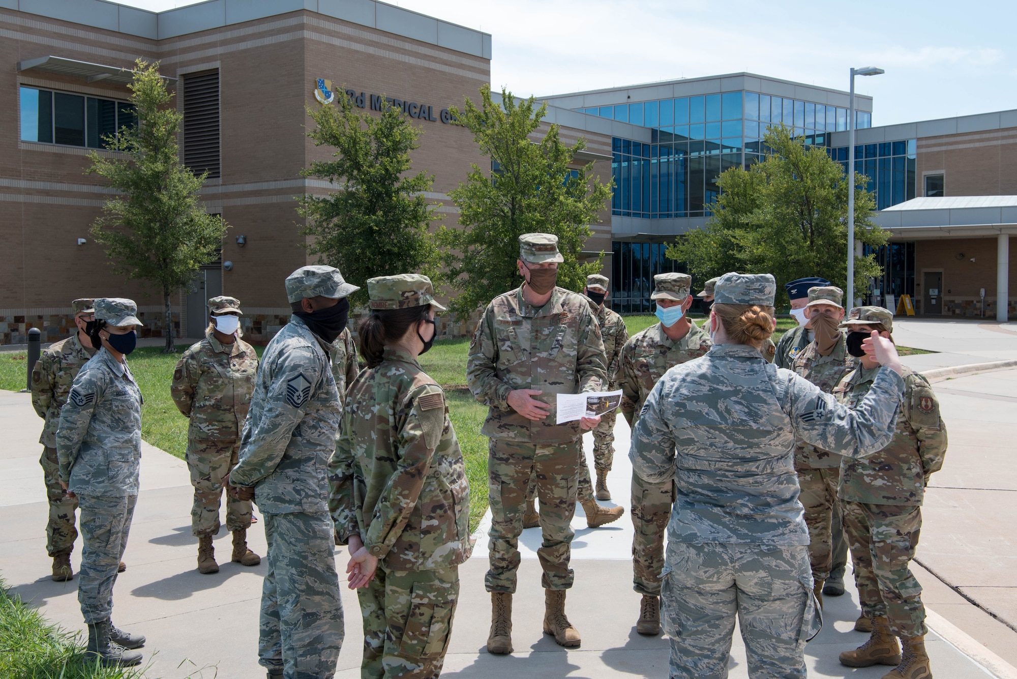 Group of Airmen standing outside of Tinker AFB Clinic