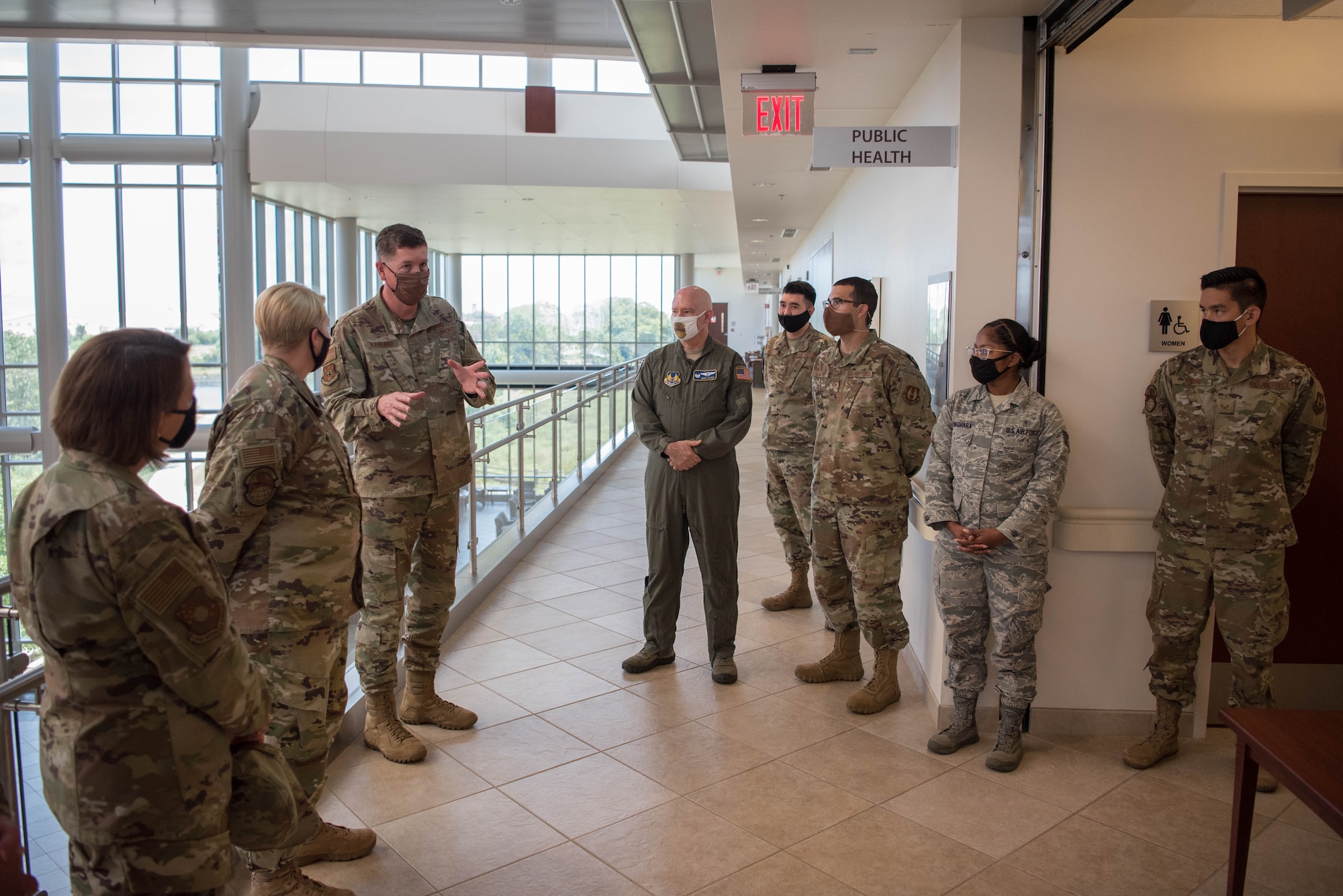 Group of Airmen listening to Lt. Gen. Kirkland in atrium of Tinker AFB Clinic