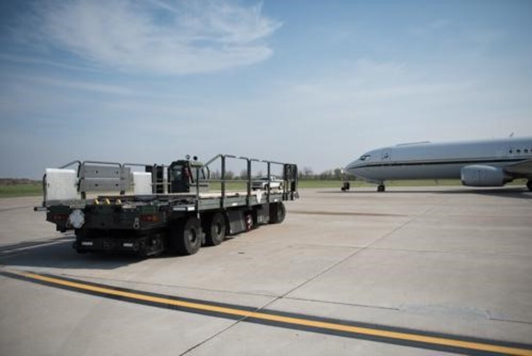An Airman from the 5th Logistics Readiness Squadron hauls cargo at Minot Air Force Base, North Dakota, May 20, 2020. The 5th LRS modified pallets with rollers in order to efficiently change the way they work missions. (U.S. Air Force photo by Airmen 1st Class Jesse Jenny)