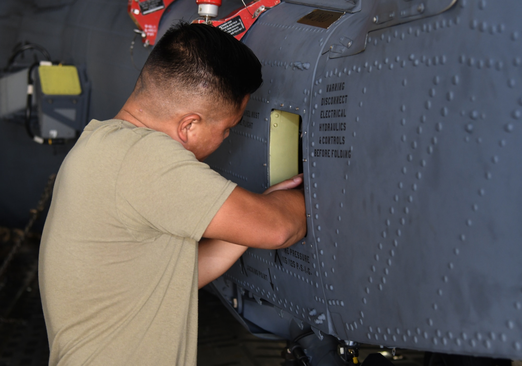 A Airman puts fuel in a helicopter.