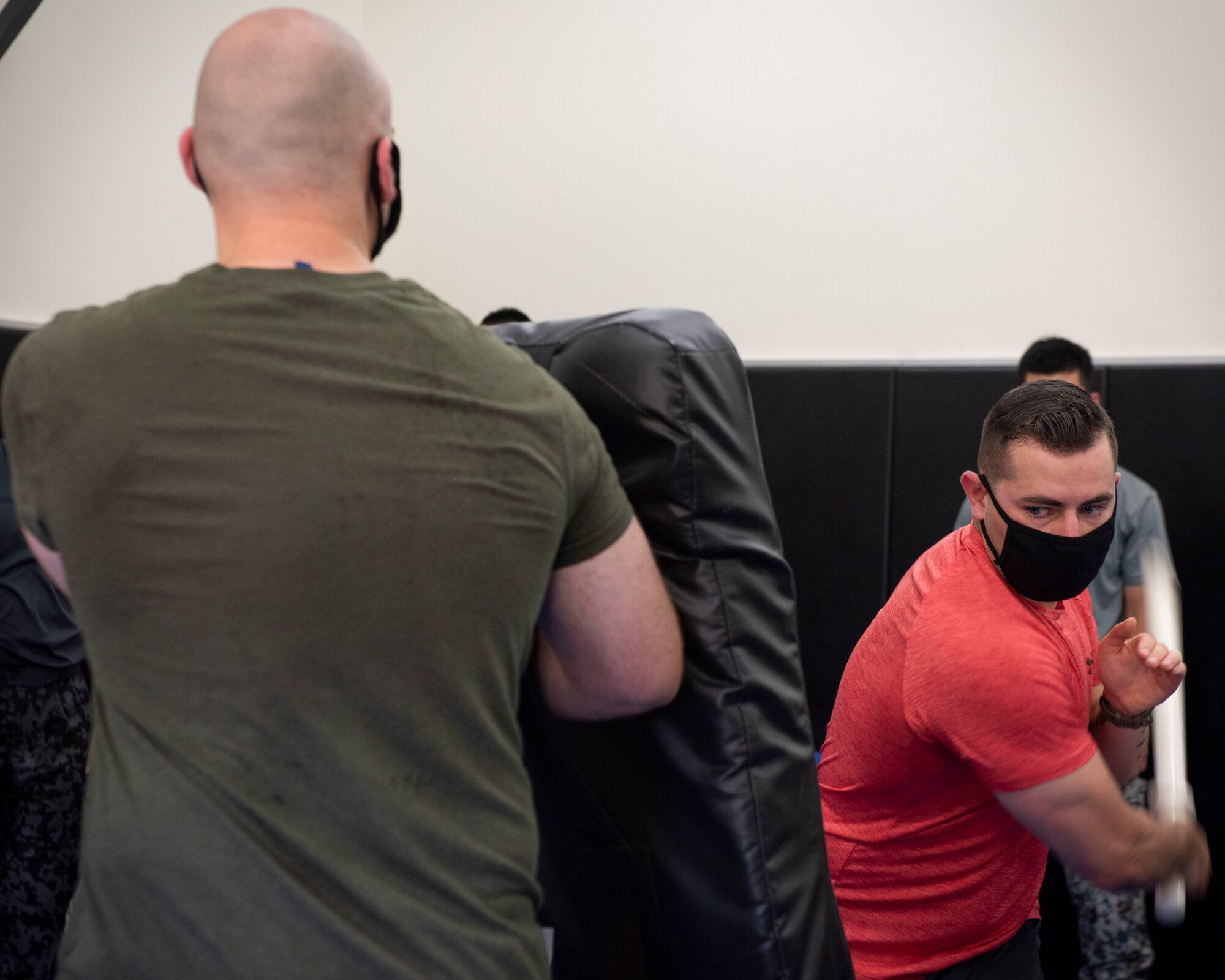 Staff Sgt. Joshua Cordova, 374th Security Forces Squadron flight sergeant, demonstrates a baton technique to Koku-Jieitai (Japan Air Self-Defense Force) members during the bilateral aircraft security training at Yokota Air Base, Japan, August 7, 2020.