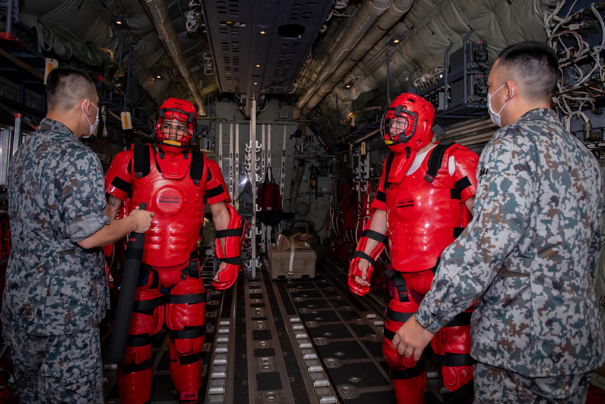 Koku-Jieitai members (Japan Air Self-Defense Force) react to simulated intruders by using verbal judo that they have learned in a class during a training scenario portion of the bilateral aircraft security training at Yokota Air Base, Japan, August 7, 2020.
