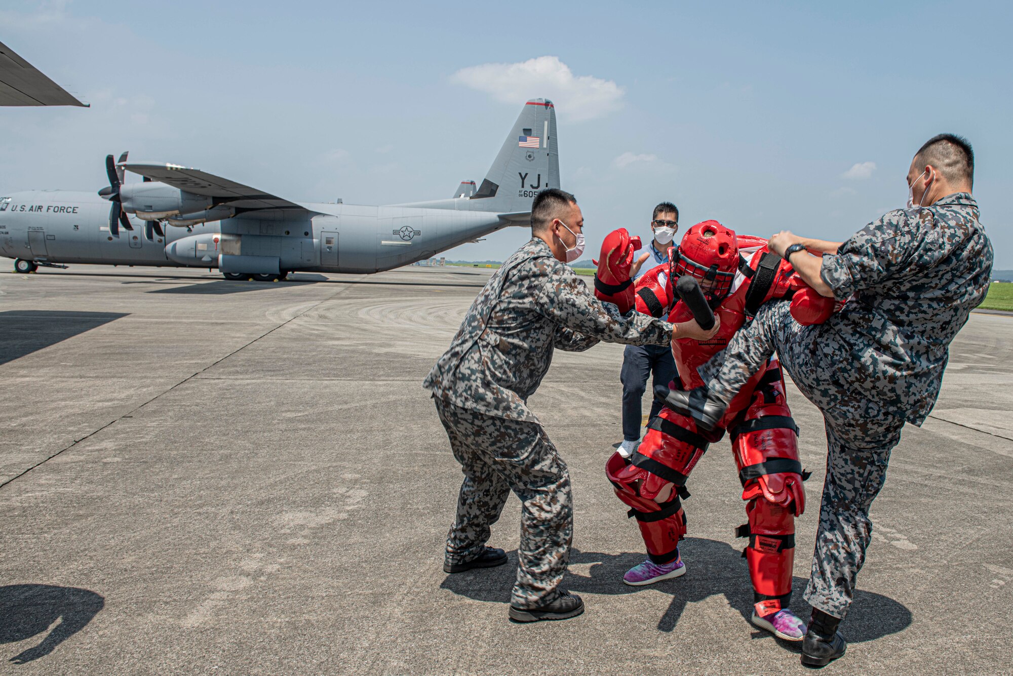 Koku-Jieitai (Japan Air Self-Defense Force) members react to simulated intruders by using combative techniques learned during a bilateral aircraft security training event at Yokota Air Base, Japan, August 7, 2020