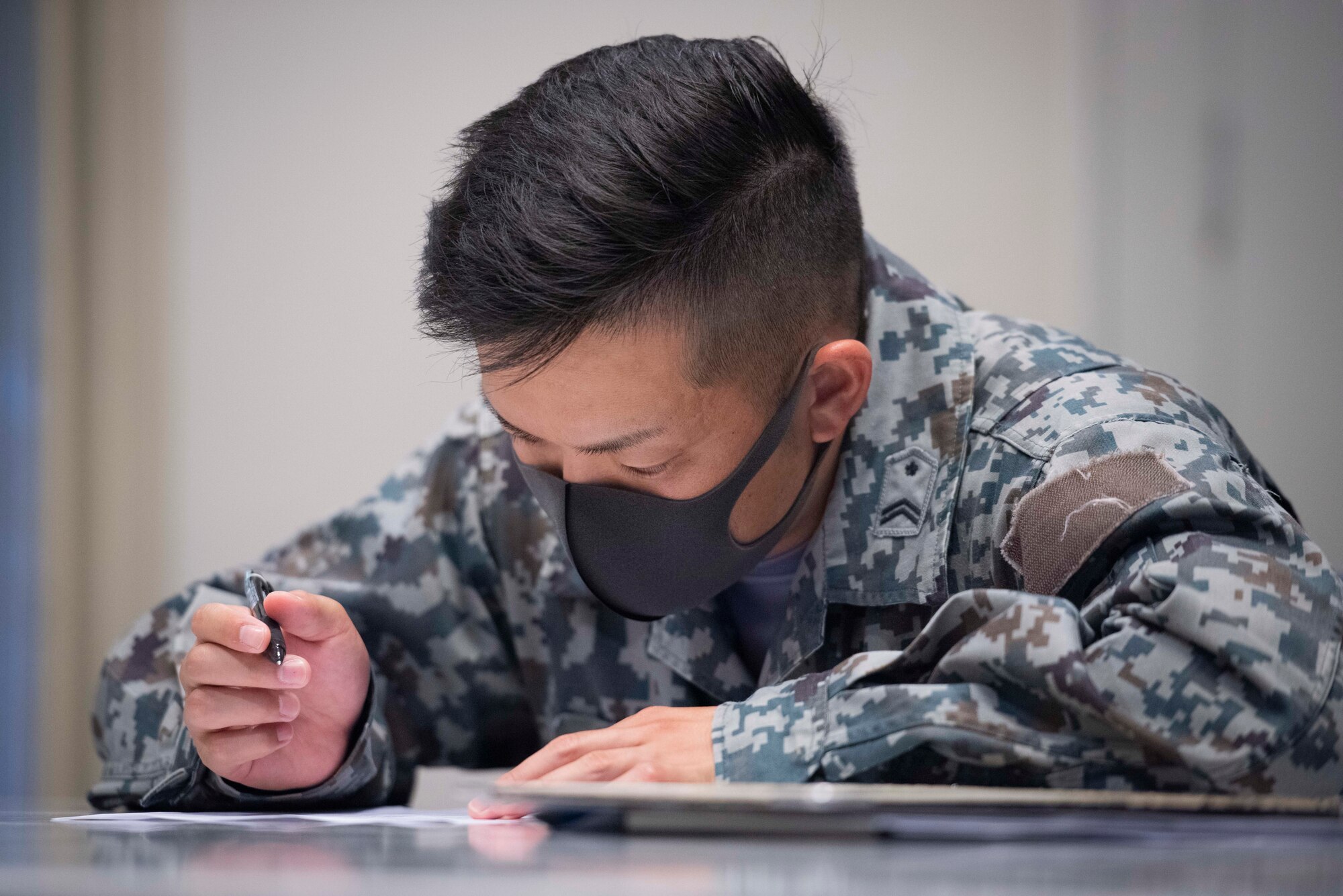 A Koku-Jieita (Japan Air Self-Defense Force) member takes a written test at the end of the class on the third day of the bilateral aircraft security training course at Yokota Air Base, Japan, August 7, 2020.