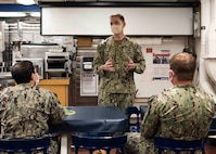 Rear Adm. Brad Cooper, commander, Naval Surface Force Atlantic, speaks to Sailors aboard the guided-missile destroyer USS Carney (DDG 64).