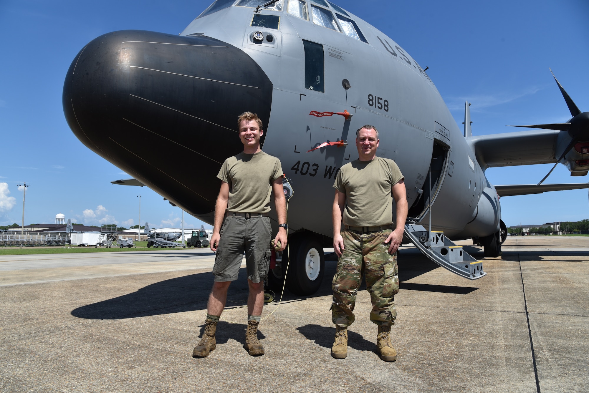 Senior Airman Robert Koltas (left), 403rd Maintenance Squadron propulsion technician, wears the authorized shorts as he stands next to Tech. Sgt. Ben Cox, 403rd MXS propulsion technician (right), in the Operational Camouflage Pattern trousers, July 17, 2020 at Keesler Air Force Base, Mississippi. (U.S. Air Force photo by Tech Sgt. Michael Farrar)