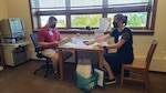 Staff Sgt. Zach Zenk, an avionics technician with the 115th Fighter Wing, and Sgt. 1st Class Lauren Tredinnick, with the 132nd Army Band, process absentee ballots at the Mount Horeb Public Library during the Aug. 11 election in Mount Horeb, Wis. Nearly 700 Citizen-Soldiers and -Airmen from the Wisconsin National Guard mobilized to serve as poll workers across 40 Wisconsin counties.