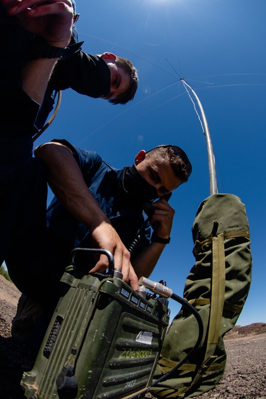 Lance Cpl. Jaden L. Kreger, left, and Lance Cpl. Ruben A. Isai, right, both field radio operators with 6th Engineer Support Battalion, 4th Marine Logistics Group, establish a radio connection in Pima County, Ariz. Aug. 8, 2020. The Innovative Readiness Training (IRT) program combines all facets of 6th ESB's capabilities with real life projects in their local community to better train their Marines. (U.S. Marine Corps photo by Lance Cpl. Christopher W. England)