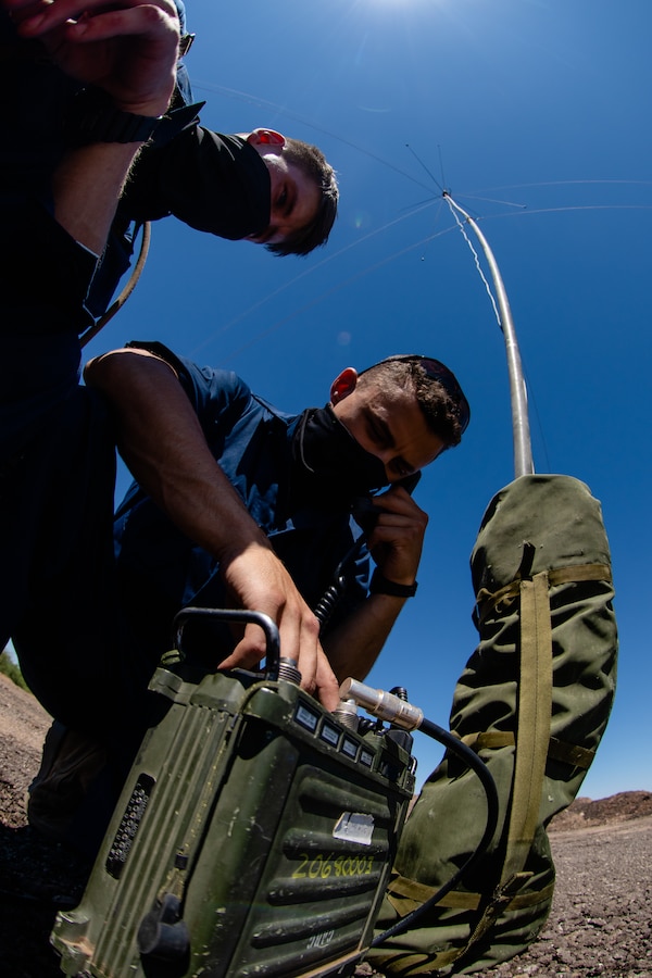 Lance Cpl. Jaden L. Kreger, left, and Lance Cpl. Ruben A. Isai, right, both field radio operators with 6th Engineer Support Battalion, 4th Marine Logistics Group, establish a radio connection in Pima County, Ariz. Aug. 8, 2020. The Innovative Readiness Training (IRT) program combines all facets of 6th ESB's capabilities with real life projects in their local community to better train their Marines. (U.S. Marine Corps photo by Lance Cpl. Christopher W. England)