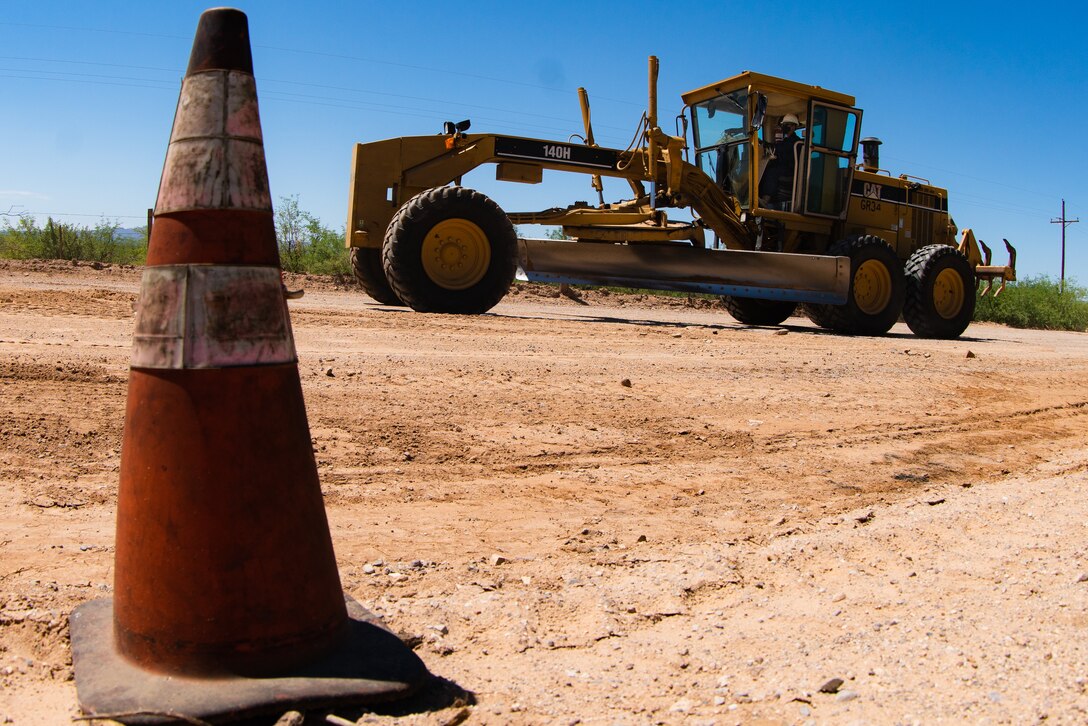 A Marine corps heavy equipment operator with 6th Engineer Support Battalion, 4th Marine Logistics Group, conducts road maintenance in Pima County, Ariz. Aug. 8, 2020. The partnership with Pima County to complete this exercise allows the unit to give back to the community and keep their skills sharp while remaining safe throughout the travel restrictions. (U.S. Marine Corps photo by Lance Cpl. Christopher W. England)