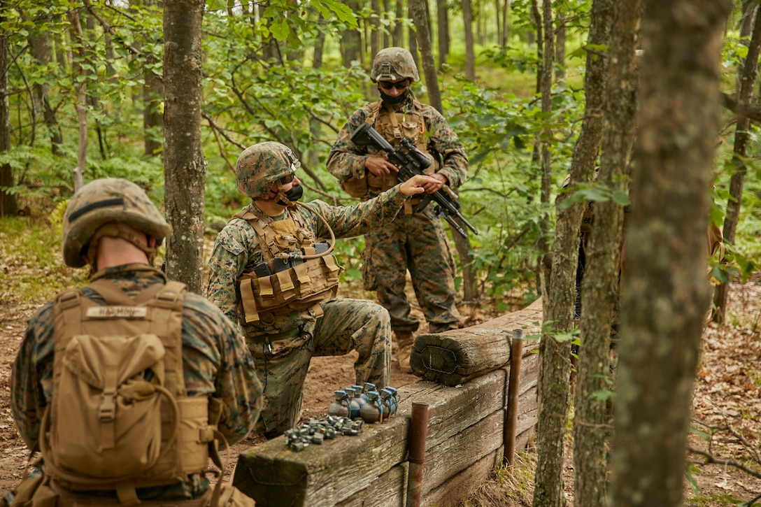 A Marine with Bravo Company, 1st Battalion, 24th Marine Regiment, 4th Marine Division, instructs other Marines on how to launch an M67 fragmentation hand grenade during an annual training exercise at Camp Grayling, Mich., Aug. 10, 2020. This training is included in the Marine's annual training and readiness manual, which gives guidance on the equipment, ammunition, ranges and support requirements to plan and execute effective training to increase Marines’ lethality. (U.S. Marine Corps photo by Lance Cpl. Leslie Alcaraz)